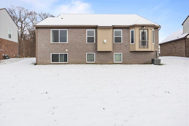 view of snow covered back of property