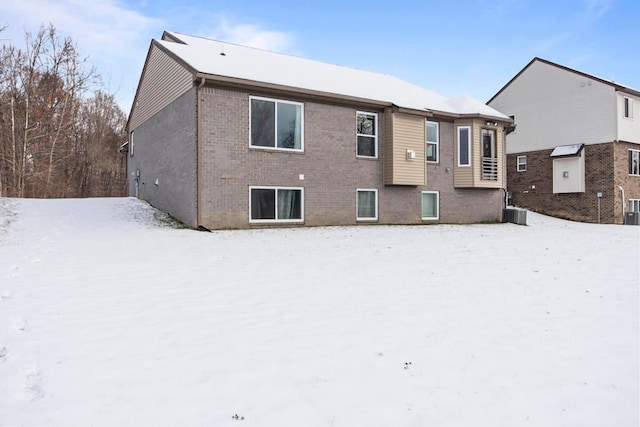 snow covered property featuring central AC unit