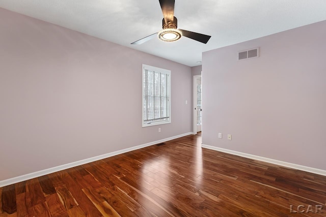 spare room featuring ceiling fan and dark wood-type flooring