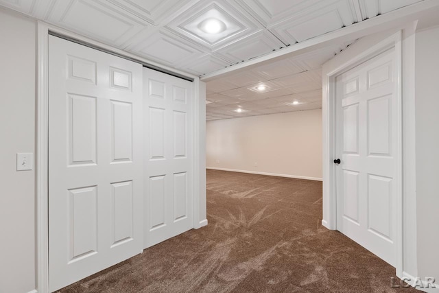 basement featuring dark colored carpet