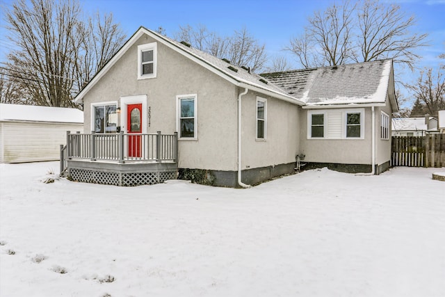 snow covered property featuring a wooden deck