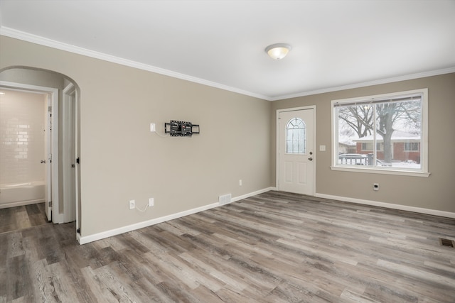 entrance foyer featuring ornamental molding and wood-type flooring