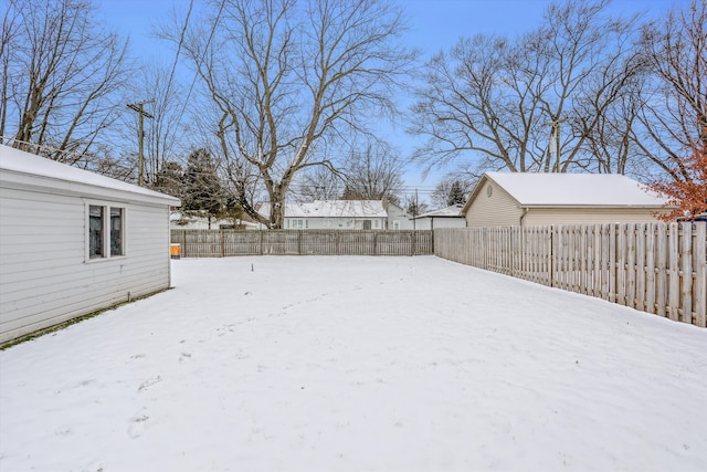 view of yard layered in snow