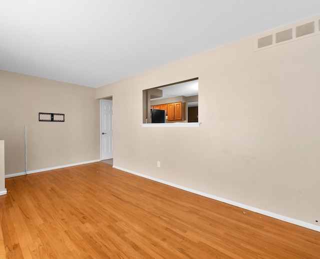 unfurnished room featuring light wood-type flooring