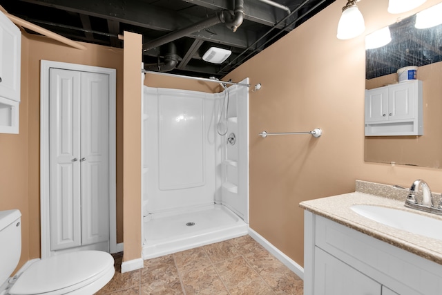 bathroom with toilet, a shower, and vanity