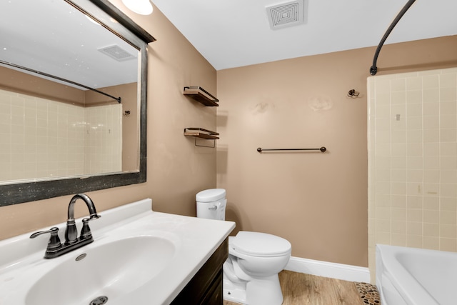 full bathroom featuring shower / tub combination, toilet, vanity, and hardwood / wood-style flooring