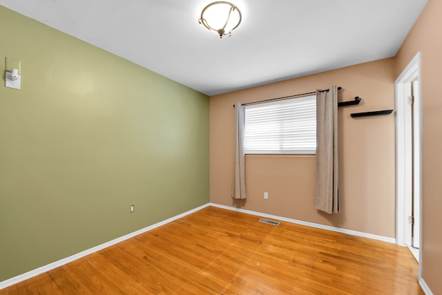 unfurnished room with light wood-type flooring