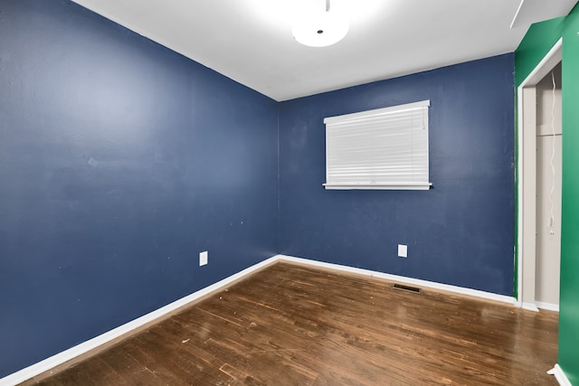 unfurnished room with hardwood / wood-style floors