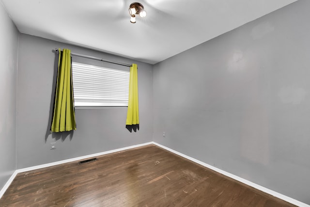 empty room with dark hardwood / wood-style floors