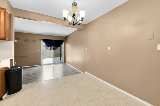 interior space featuring beamed ceiling, a notable chandelier, and light hardwood / wood-style flooring