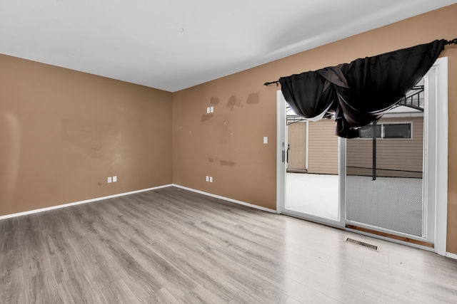 spare room featuring light hardwood / wood-style flooring