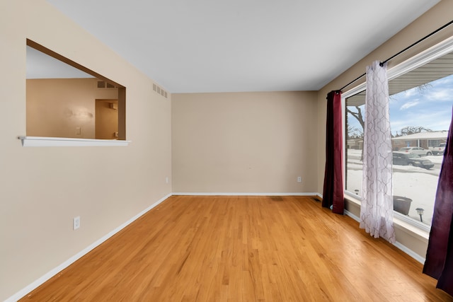 spare room with light hardwood / wood-style flooring