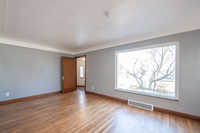 empty room with light hardwood / wood-style flooring