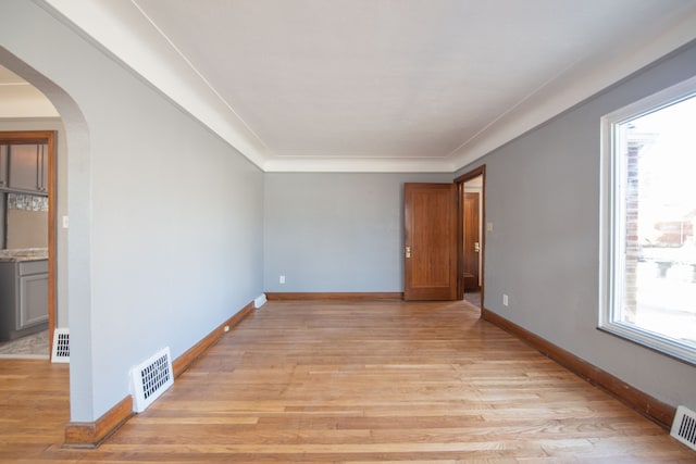 spare room with light hardwood / wood-style flooring and ornamental molding