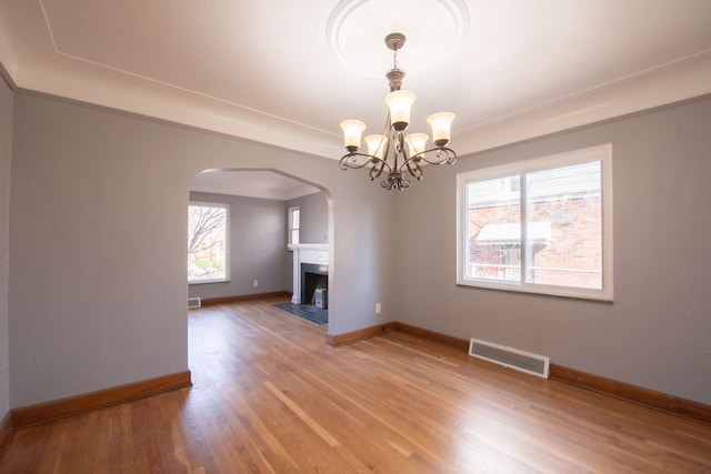 interior space with hardwood / wood-style flooring, plenty of natural light, and an inviting chandelier