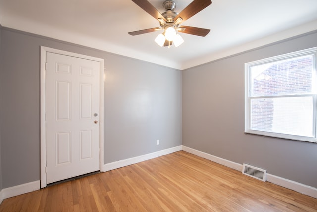 spare room with crown molding, ceiling fan, and light hardwood / wood-style floors