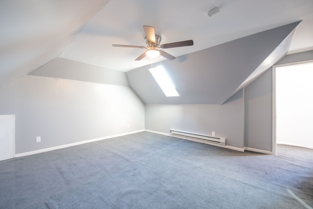 bonus room featuring carpet, lofted ceiling with skylight, ceiling fan, and a baseboard heating unit