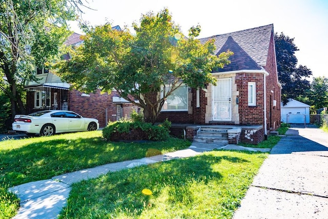 view of front facade featuring an outbuilding, a front yard, and a garage