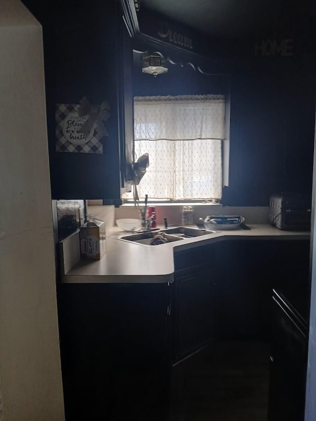 kitchen featuring light countertops and a sink