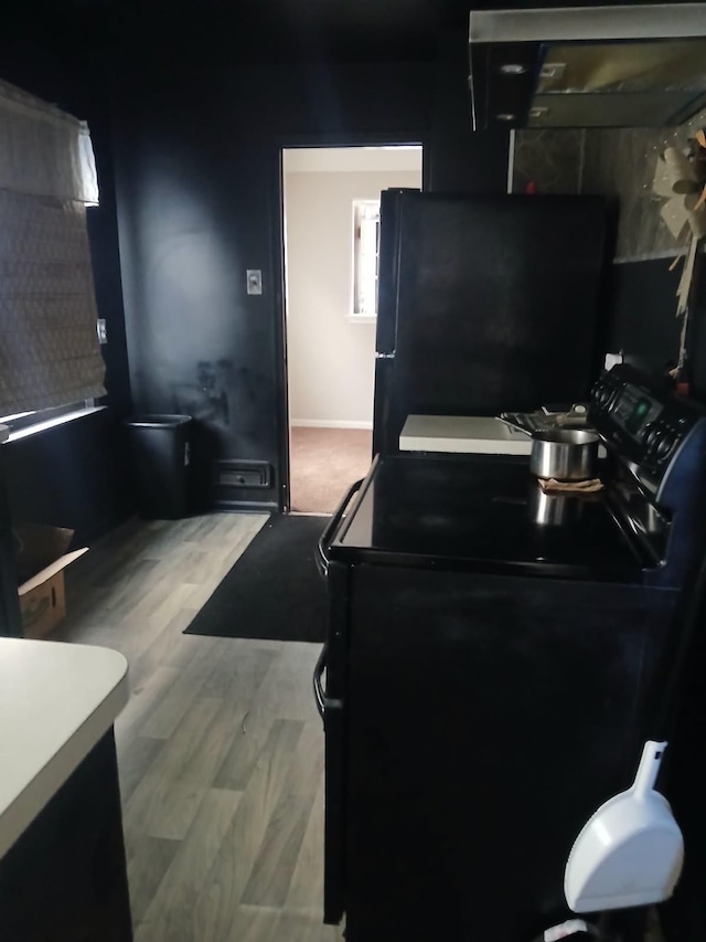 kitchen featuring black appliances and wood finished floors