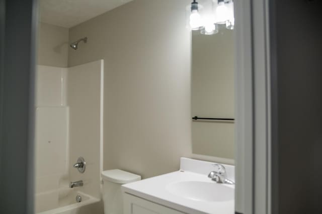 full bathroom featuring bathing tub / shower combination, vanity, and toilet