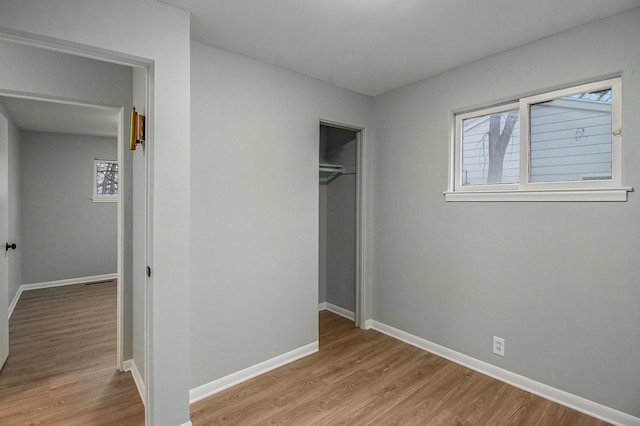 unfurnished bedroom with light hardwood / wood-style floors and a closet