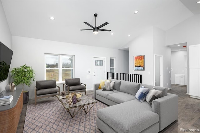 living room featuring dark wood-type flooring, high vaulted ceiling, and ceiling fan