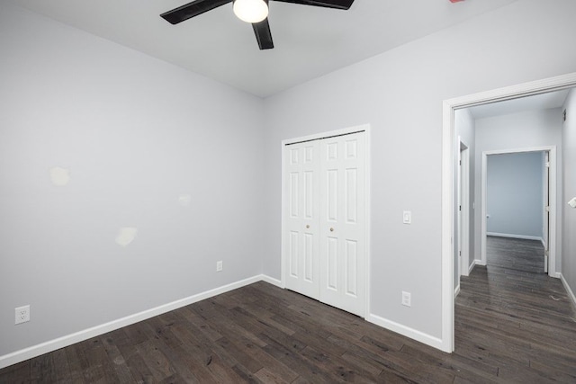 unfurnished bedroom with ceiling fan, dark hardwood / wood-style flooring, and a closet