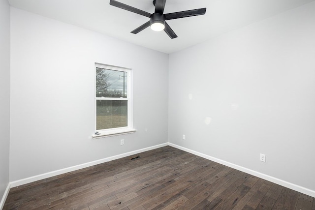 empty room with ceiling fan and dark hardwood / wood-style floors