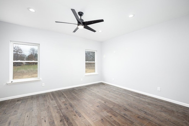 spare room featuring ceiling fan and dark hardwood / wood-style floors