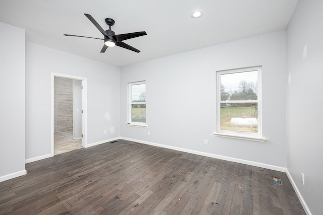 spare room featuring ceiling fan and dark hardwood / wood-style flooring