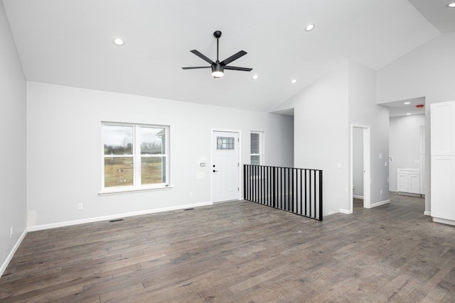 unfurnished living room featuring dark wood-type flooring, ceiling fan, and high vaulted ceiling