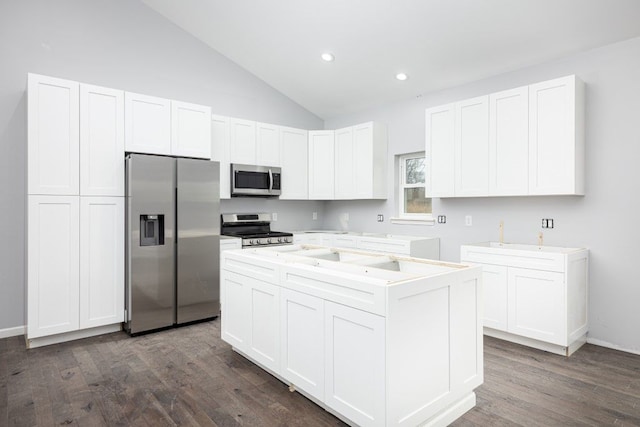 kitchen featuring appliances with stainless steel finishes, dark hardwood / wood-style flooring, white cabinets, and a kitchen island