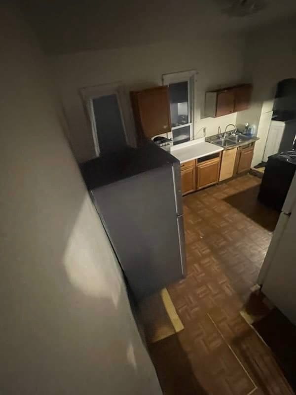 kitchen featuring sink and dark parquet floors