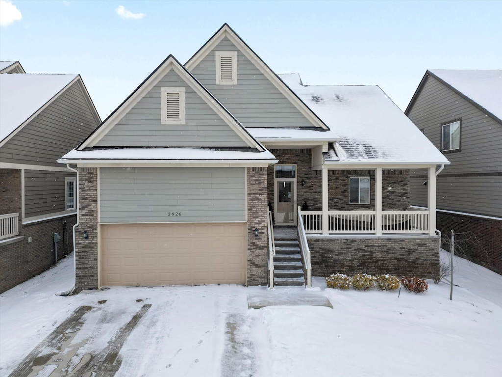 view of front of property featuring covered porch and a garage