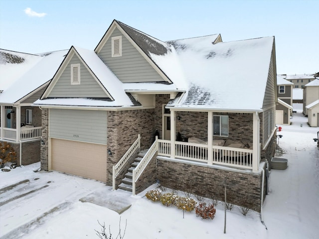 view of front of property with a porch and a garage