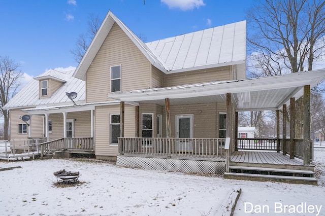 view of front of property with covered porch and a fire pit