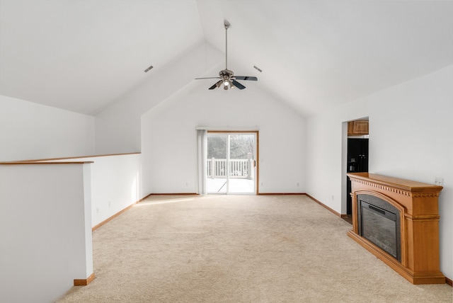 unfurnished living room with vaulted ceiling, ceiling fan, and light carpet