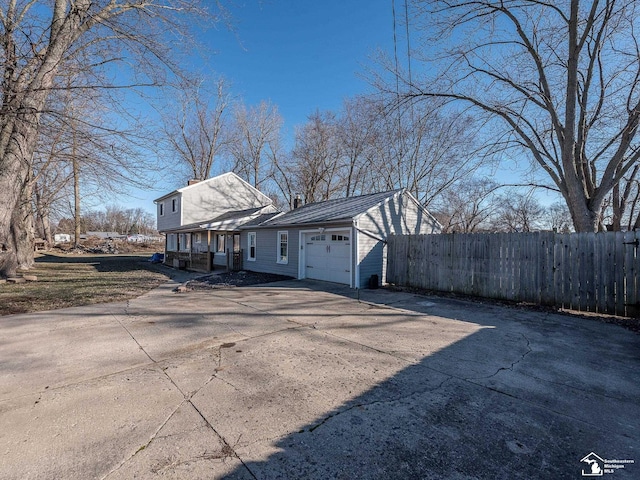 view of home's exterior featuring covered porch and a garage