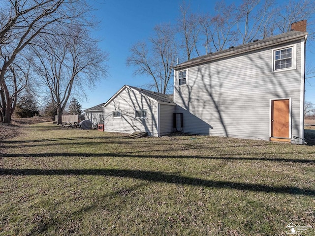 rear view of house with a yard