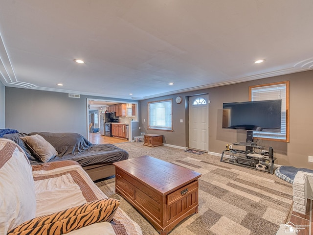 carpeted living room with crown molding