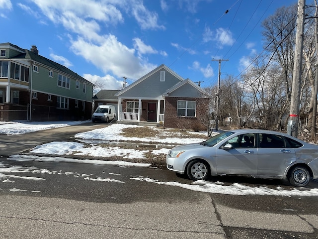 view of front of property featuring a porch and brick siding