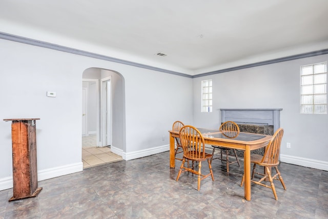 dining room featuring crown molding and a wealth of natural light