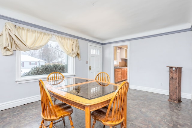 dining space with ornamental molding