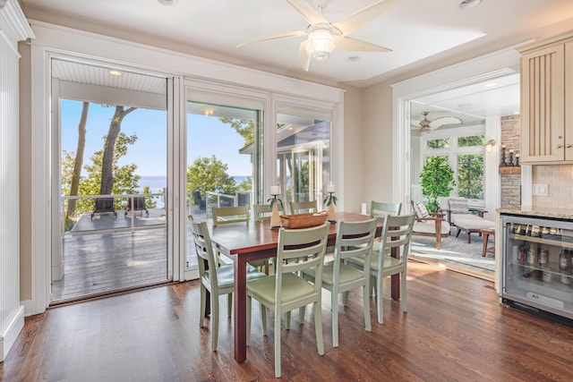 dining area featuring beverage cooler, plenty of natural light, and dark wood finished floors