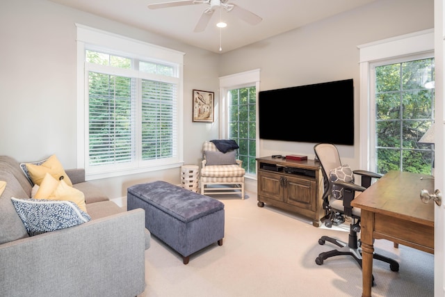 interior space with a ceiling fan and light carpet