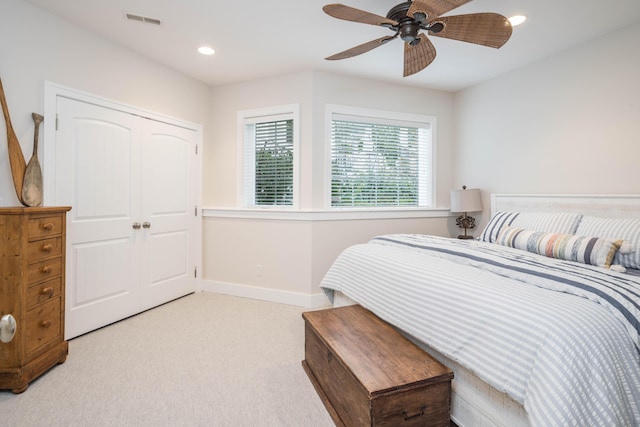bedroom with light carpet, baseboards, visible vents, a closet, and recessed lighting