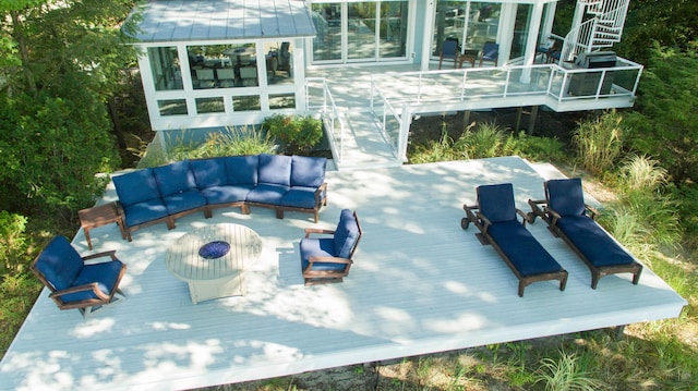 view of patio with a deck, an outdoor hangout area, stairs, and a sunroom