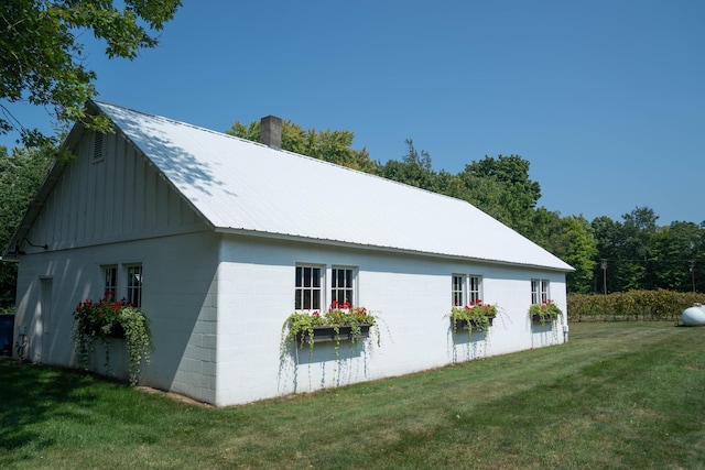 view of property exterior with a lawn