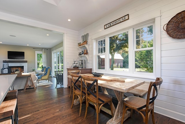 dining room with wood walls and dark hardwood / wood-style flooring